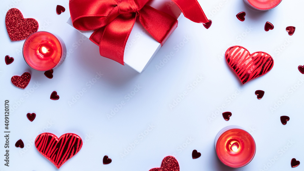 Happy days background. Red love hearts, romantic gift box, Valentines day candle on white table. Romantic message template with copy space. Top View. View from above. Happy days background. Red love hearts, romantic gift box, Valentines day candle on white table. Romantic message template with copy space. Top View. View from above.
