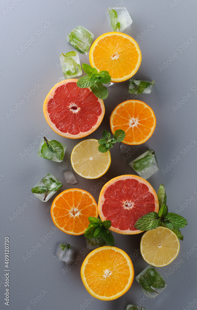 Creatively laid out citrus fruits on gray background. Top view of oranges, lemons, tangerines, grapefruit.Preparation of drinks. Citrus juice ingredients, food background Creatively laid out citrus fruits on gray background. Top view of oranges, lemons, tangerines, grapefruit.Preparation of drinks. Citrus juice ingredients, food background