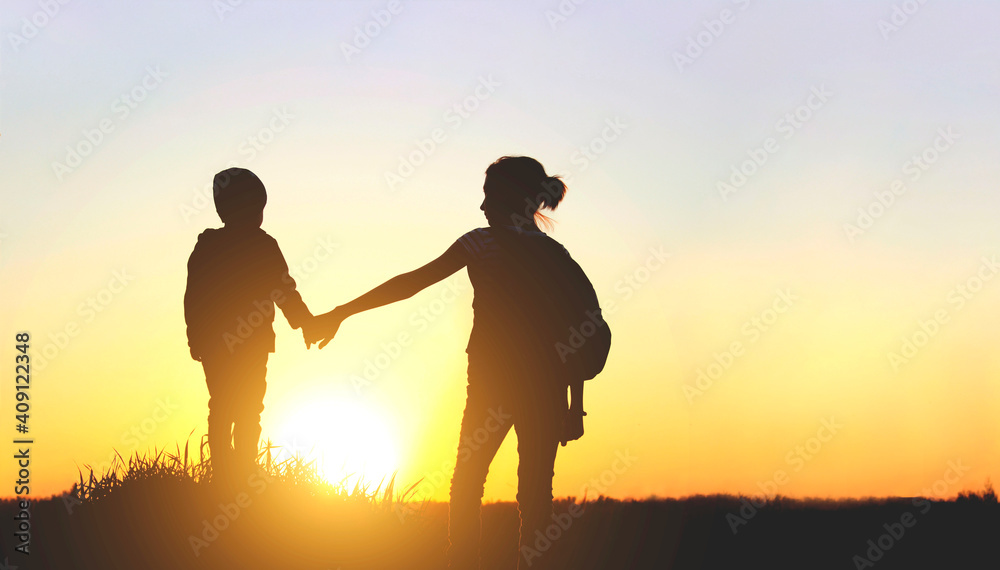 Friendly family, children, travel, family value concept. Elder sister and her younger brother looking on sunset. Children walking at sunset.