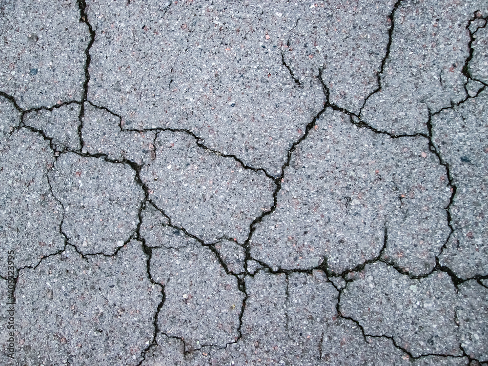 Burst asphalt texture. The road is in need of repair. Old grain effect. Burst asphalt texture. The road is in need of repair. Old grain effect.