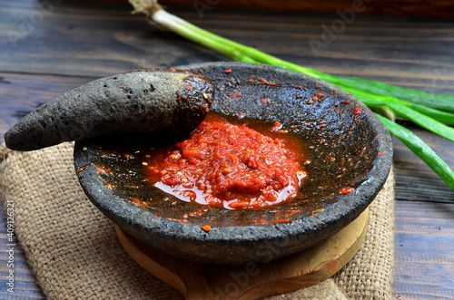 sambal tomat ulek or tomato sauce grind, traditional food from indonesia made from tomato chilli onion and gralic photo