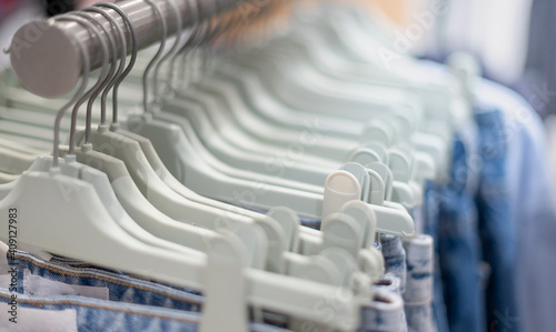 Obraz na plátně Modern fashion women clothes hang on stanless steel hangers rack at clothing store department store
