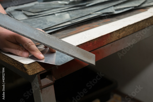 Craftsman Polishes Sharp Metal Edge
