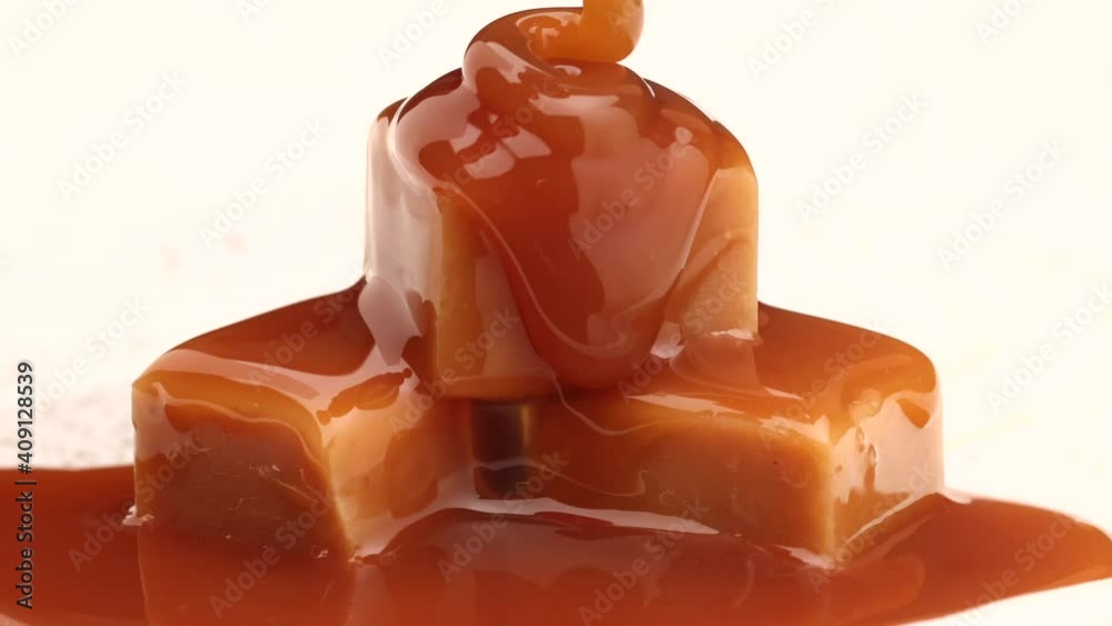 melted caramel sauce flowing on caramel candies close up