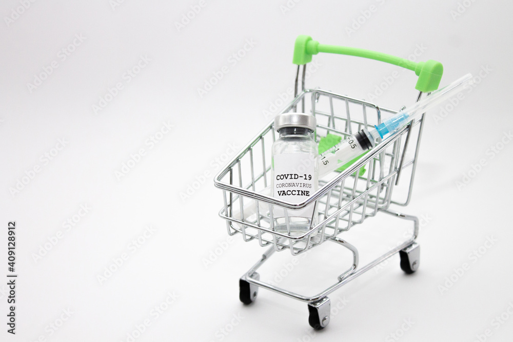 Shopping cart and COVID-19 vaccine bottle with space for text. Buy coronavirus vaccine concept.