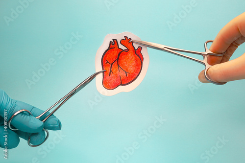 Heart surgery. Medical instruments and drawing of heart on blue background.