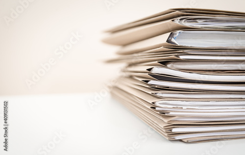 Extremely Close up Stack of Documents Folders on Office Desk Waiting to be Completed photo