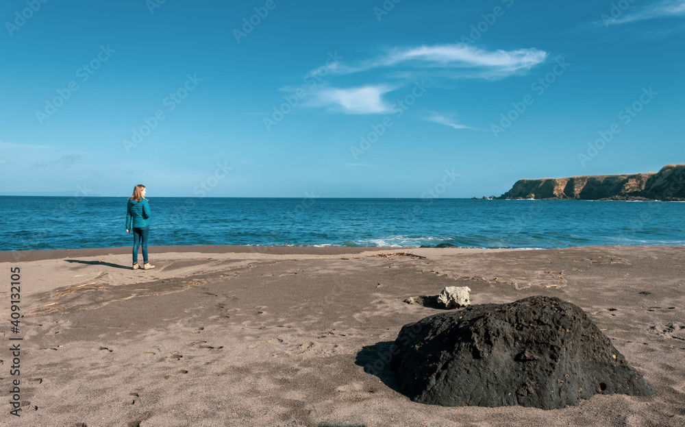 One person at beach, woman, solo, black sand, Azores, Sao Miguel island, travel destination.