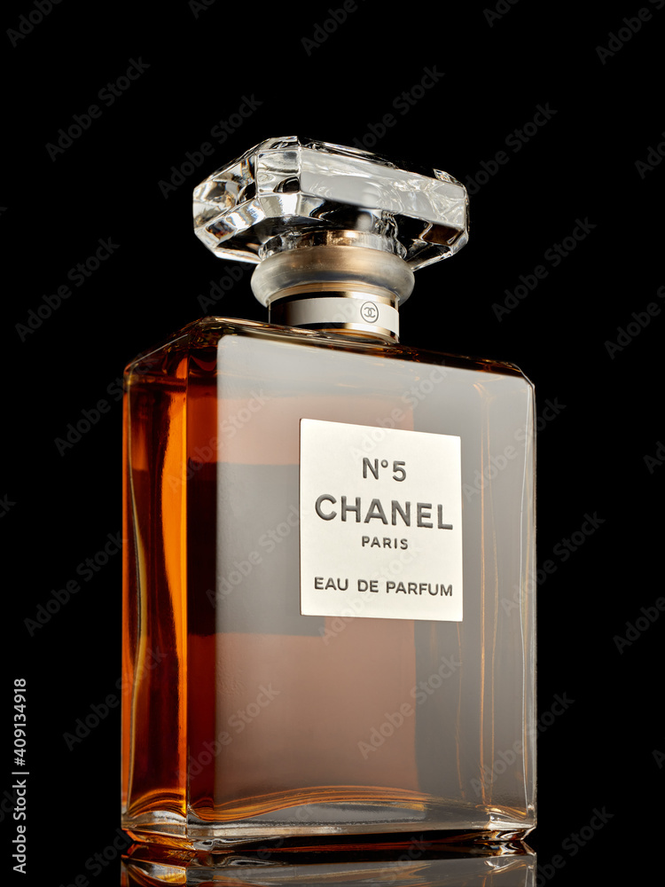 finger Indsigt harpun Bottle of perfume Chanel № 5. on black background. Coco Chanel Stock Photo  | Adobe Stock