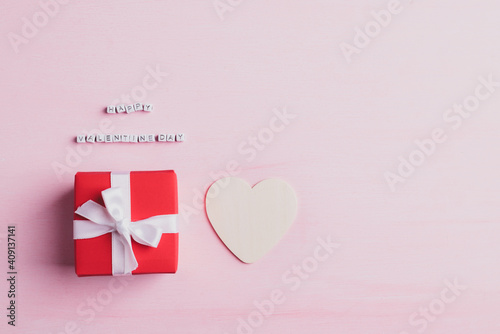 Happy valentine day alphabet with red gift box and heart shape on pink background