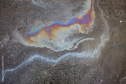 Oil stain on Asphalt, color Gasoline fuel spots on Asphalt Road as Texture or Background.