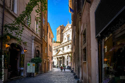Day view of a shaded alley and the Church of Sant' Eustachio with the head of a white stag holding it's cross in historic Rome, Italy. © Kirk Fisher