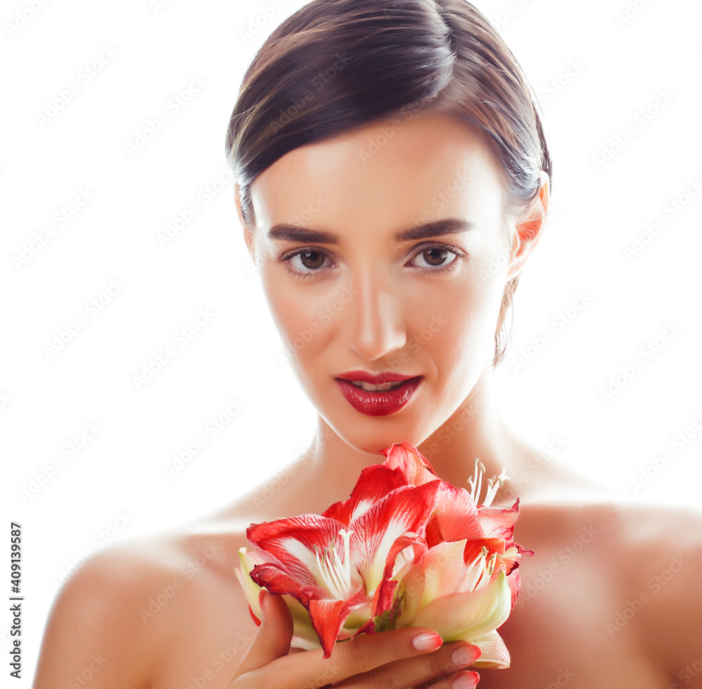 Fototapeta premium young pretty brunette real woman with red flower amaryllis close up isolated on white background. Fancy fashion makeup, bright lipstick, creative Ombre manicured nails