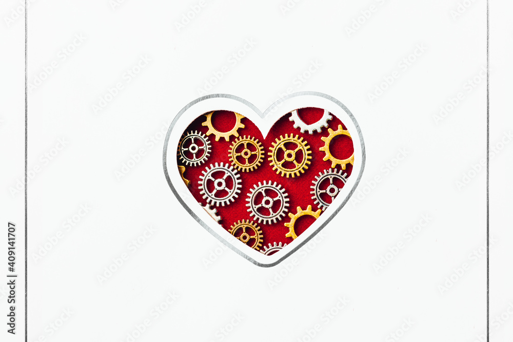 white postcard with heart shape made of gears on red background