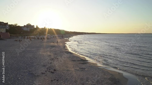overlook over beautiful sunset at beach at baltic sea with sunstar and waves rolling in