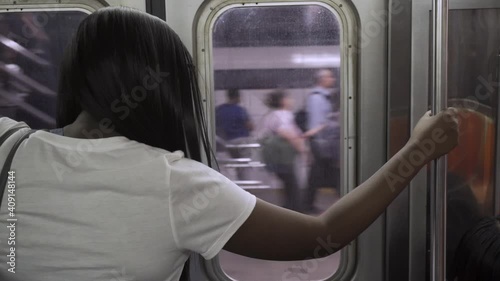 Traveling by subway in a big city. The young African woman waits to get off