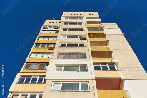 High apartment building of Soviet construction bottom view of a tall panel house isolated on vivid blue sky background in Sofia, Bulgaria, Eastern Europe