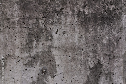 Grey texture of old broken asphalt road or wall big abrasions cracks holes on the surface pebbles cement in Sofia, Bulgaria, Eastern Europe