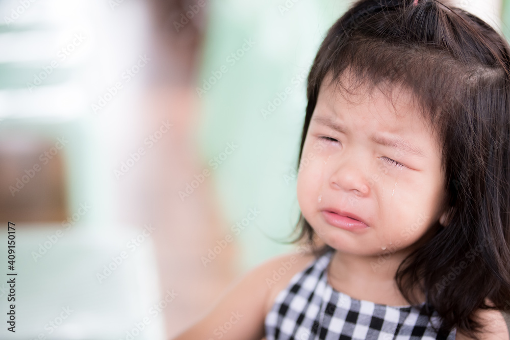 Close up of Preschool cute Asian child girl is crying. She had tears streaming down her cheeks. Cry from physical pain. Children 3 years old. Close up of Preschool cute Asian child girl is crying. She had tears streaming down her cheeks. Cry from physical pain. Children 3 years old.