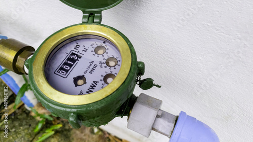 Water meter on concrete background, Measuring device, Open cover of water meter to check counter number of water consumption, water pipe and meter with waterspout of home