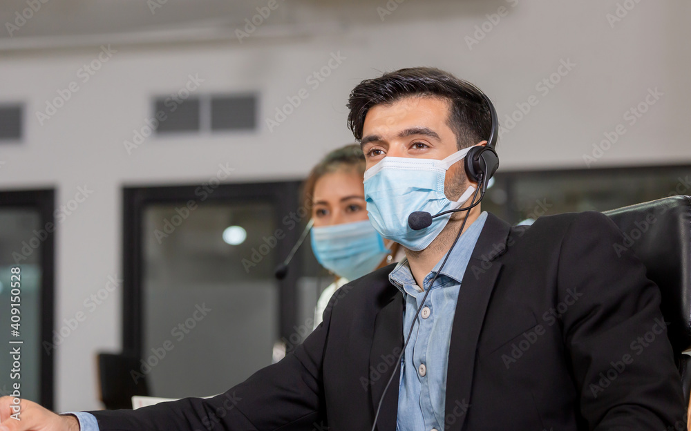 Young telephone operator with headset wear protection face mask against coronavirus, Customer service executive team working at office