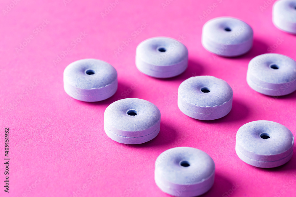 Tablet and colorful surface layer. The image of medicine and candy.