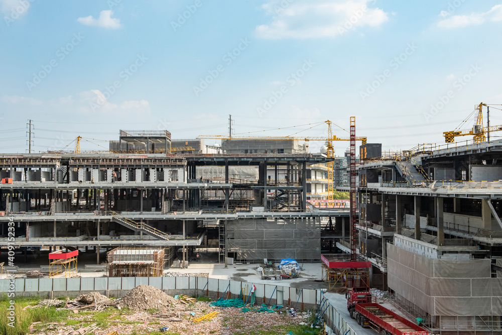 Naklejka premium Construction site background. Crane and building under construction