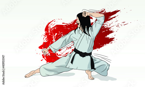 A karate girl stands in a combat position for striking.