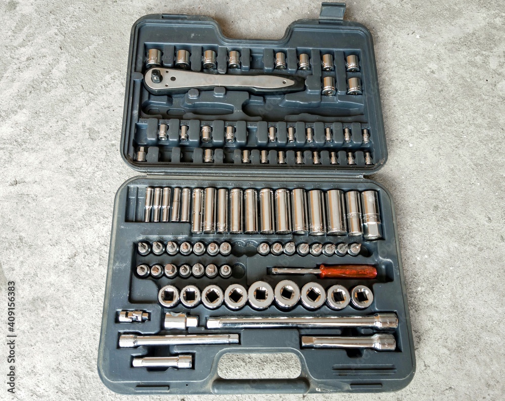 An open tool box placed on the above view. Car accessories or spare parts, garage. An open tool box placed on the above view. Car accessories or spare parts, garage.