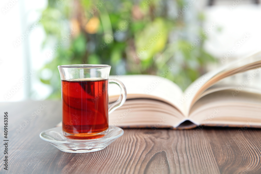 Open book and a cup of black tea Open book and a cup of black tea
