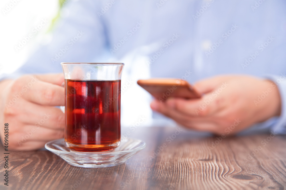 Tea drinkers playing with mobile phones Tea drinkers playing with mobile phones