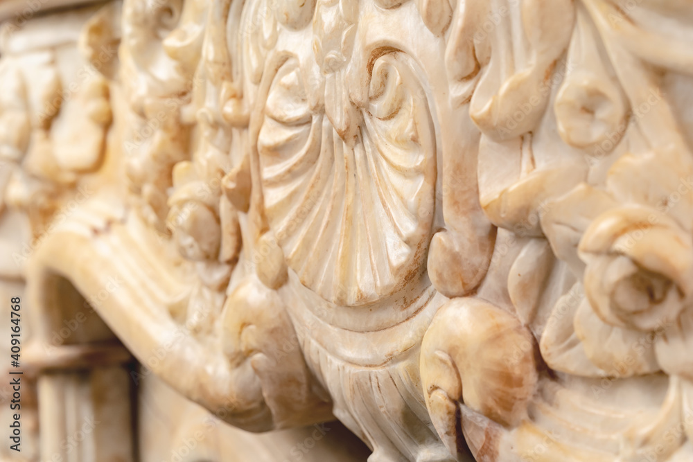 Carved patterns on stone luxury fireplace close up