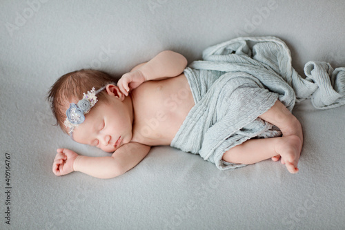 Cute newborn baby sleeping on gray blanket. Baby goods packaging template. Healthy and medical concept. Copy space