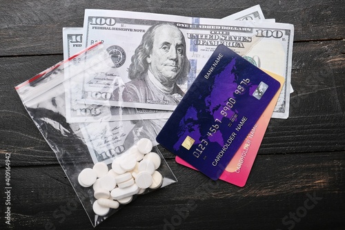 Drugs and money on wooden b...