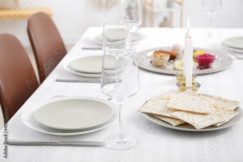 Jewish flatbread matzo on table setting for Passover Seder