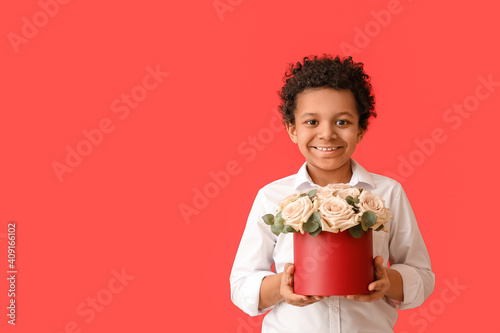 African-American boy with bouquet of beautiful flowers on color background © Pixel-Shot