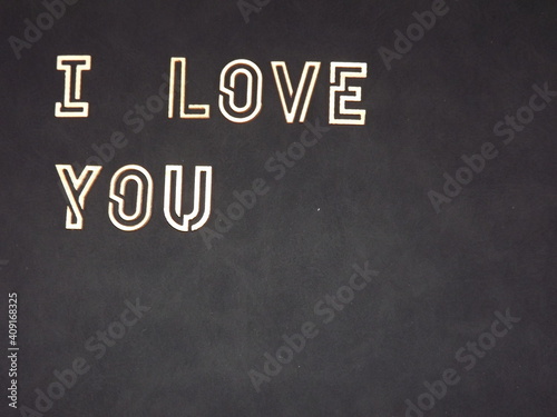 the words I love you and hearts made of wood on Valentine's day. High quality photo