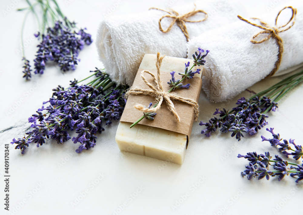 Spa setting with natural soap, towels and lavender.. Spa setting with natural soap, towels and lavender..