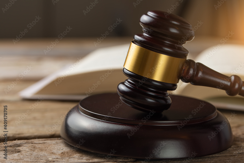 Court and justice. Judge's hammer on a wooden table against the background of books, constitution Court and justice. Judge's hammer on a wooden table against the background of books, constitution