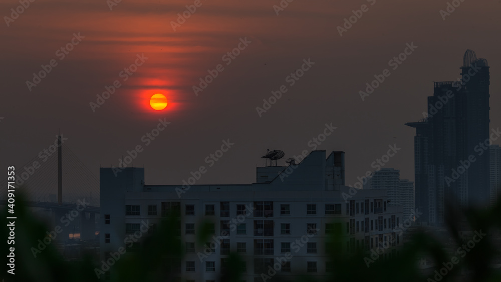 A blurred abstract background view of the rising sun, the horizon and the constantly blowing leaves of the trees, the ecological beauty that spontaneously occurs during the day.