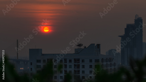 A blurred abstract background view of the rising sun  the horizon and the constantly blowing leaves of the trees  the ecological beauty that spontaneously occurs during the day.