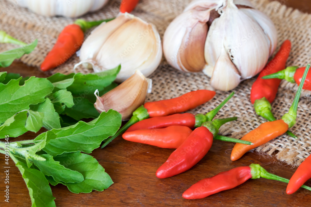 garlic ,pepper and basil fresh vegetable prepare to cook arrangment fla lay style on background wooden garlic ,pepper and basil fresh vegetable prepare to cook arrangment fla lay style on background wooden