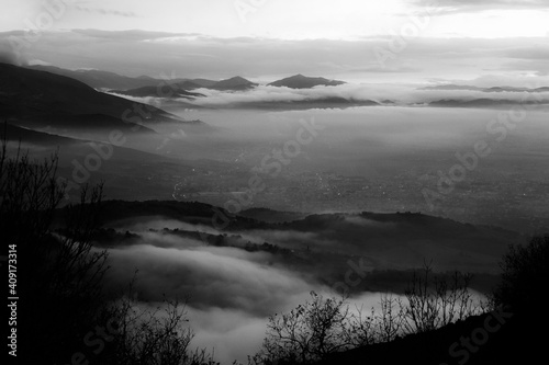 Mist and fog between valley and layers of mountains and hills