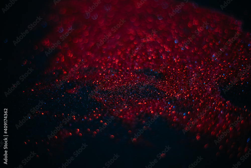 Red sand from sequins. Scattered sparkles on a black background. Space texture. Stars Red sand from sequins. Scattered sparkles on a black background. Space texture. Stars