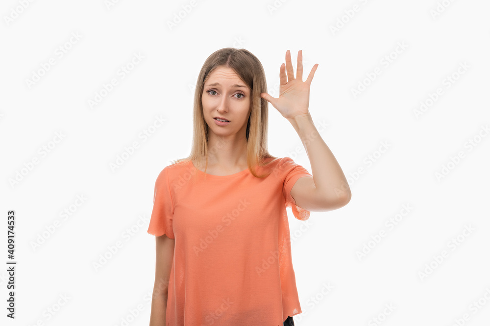 Portrait of annoyed blond girl rolling finger near temple, showing shock after hearing something stupid or insane Portrait of annoyed blond girl rolling finger near temple, showing shock after hearing something stupid or insane