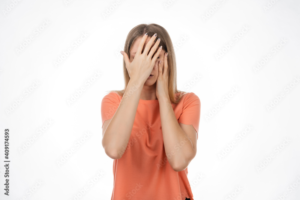 Portrait of scared blond girl hold hands near face trembling fear, very terrified. Human emotions concept Portrait of scared blond girl hold hands near face trembling fear, very terrified. Human emotions concept