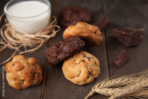Cookies on a wooden table with a glass of milk