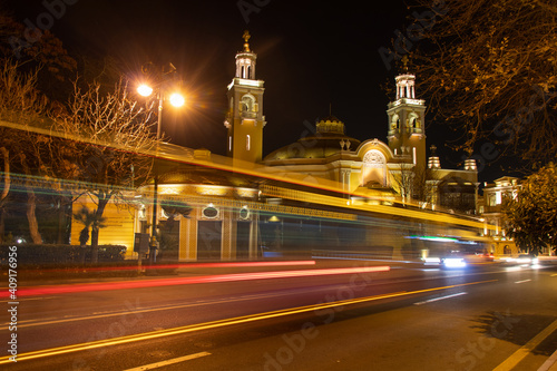 Car and bus traffic lights on Baku street at night. Philarmonic Hall at night time