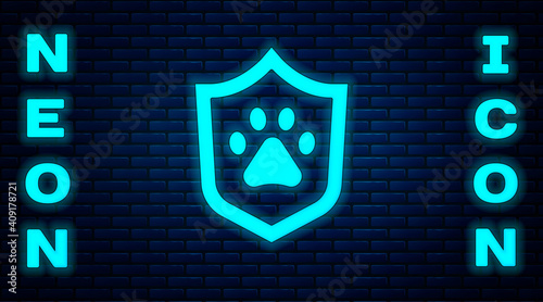 Glowing neon Animal health insurance icon isolated on brick wall background. Pet protection concept. Dog or cat paw print. Vector.