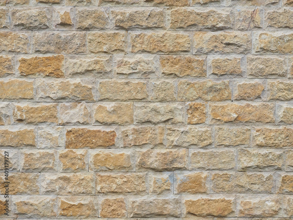 Fototapeta premium Wall with a rough textured cladding of beige red rectangular tiles. Not seamless texture